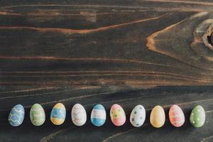 Colorful easter eggs on wooden table background vintage with copy space. photo