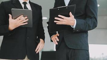 Financial analysts analyze business financial reports on a digital tablet planning investment project during a discussion at a meeting of corporate showing the results of their successful teamwork. video