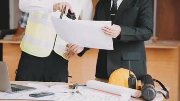 architect man working with laptop and blueprints,engineer inspection in workplace for architectural plan,sketching a construction project ,selective focus,Business concept vintage color video