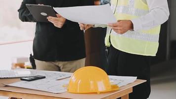 architect man working with laptop and blueprints,engineer inspection in workplace for architectural plan,sketching a construction project ,selective focus,Business concept vintage color video