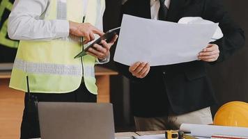 architect man working with laptop and blueprints,engineer inspection in workplace for architectural plan,sketching a construction project ,selective focus,Business concept vintage color video
