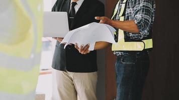 architect man working with laptop and blueprints,engineer inspection in workplace for architectural plan,sketching a construction project ,selective focus,Business concept vintage color video