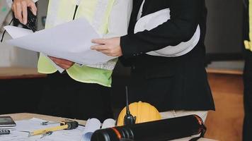 architect man working with laptop and blueprints,engineer inspection in workplace for architectural plan,sketching a construction project ,selective focus,Business concept vintage color video