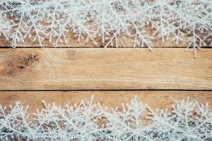 Wooden brown christmas background and snowflakes with space. photo