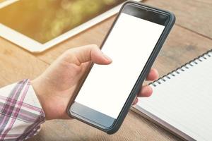 close up woman hand holding phone blank white screen display with vintage toned. photo