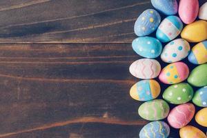 Top view of Easter eggs on rustic wood background with copy space photo