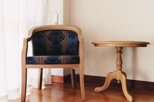 Vintage chair and table at window in the room. photo