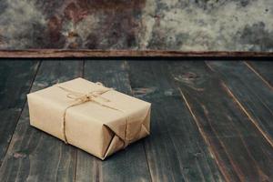 brown gift box on wooden table background with copy space. photo