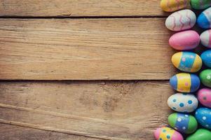 Colorful easter egg on wood background with space. photo
