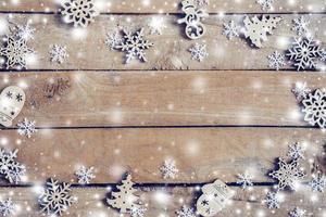 Wooden brown christmas background and snow white with snowflakes, copy space. photo