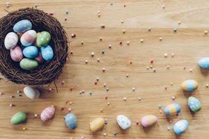 Easter eggs on on wood background top view with natural light. Flat lay style. photo