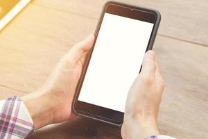 close up woman hand holding phone blank white screen display with vintage toned. photo