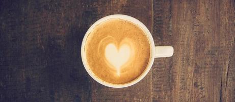 panorama shot of Latte art coffee on wood table photo