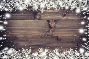 Wooden brown christmas background and snow white with snowflakes, copy space. photo