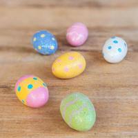 Colorful easter eggs on plank wooden background with space. photo