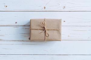 Above brown gift box on wooden table background with copy space. photo