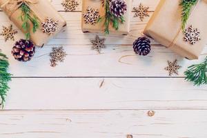 Homemade wrapped christmas gift box presents on a wood table background with space. photo