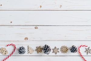 Wooden white and christmas background with snowflakes, pine cones and christmas decoration. photo