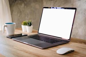 Laptop computer with blank screen on table. photo