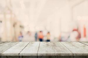 Empty wooden table and Blurred background - Store of shopping mall blur background bokeh with display montage for product. photo