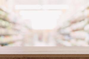 Empty wooden table top with blurred modern shopping mall background for product display and montage. photo