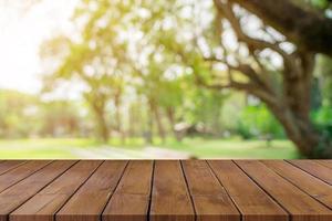 Empty wooden table top and green bokeh display montage for product with space. photo