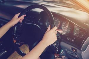 woman driver hands holding steering wheel driving a car photo