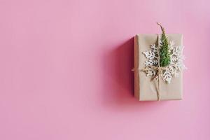 Brown gift box on the pink background. Minimal styled holiday card with copy space. photo