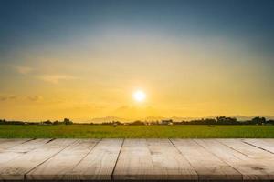 Rice field sunset and Empty wood table for product display and montage. photo