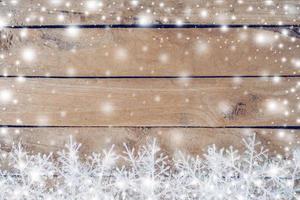 Wooden brown christmas background and snow white with snowflakes, copy space. photo