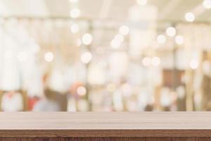 Empty wooden table with blurred abstract people on cafe on restaurant background. photo