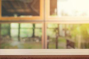 Empty wooden table and blurred people in coffee shop background, product display montage. photo