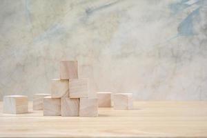 Wooden toy cubes on wooden table ang grey background photo