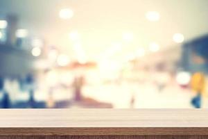 Empty wooden table for product placement or montage and blurred terminal department at airport background. photo