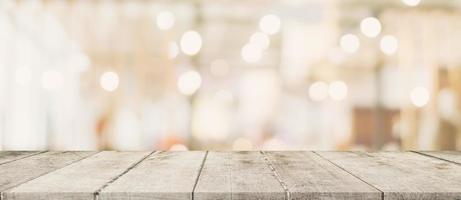 Empty wood table and blurred light table in shopping mall with bokeh background. product display template. photo