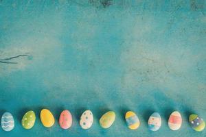 Colorful easter egg on blue pastel color wood background with space. photo