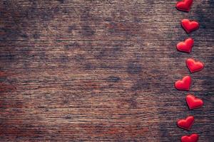 Red heart on wood background with space for Valentine Day. photo