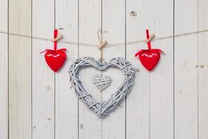 wooden rustic decorative hearts hanging on vintage wooden background with space. photo