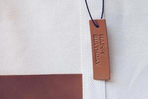 Close up Leather tag on bag with text Happy birthday photo