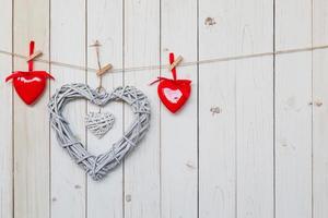 wooden rustic decorative hearts hanging on vintage wooden background with space. photo