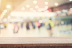 Empty wooden table for product placement or montage and blurred terminal department at airport background. photo