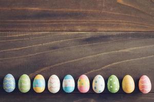 Top view of Easter eggs on rustic wood background with copy space photo
