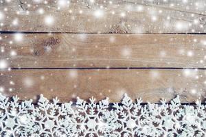 Wooden brown christmas background and snow white with snowflakes, copy space. photo