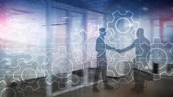 Double exposure gears mechanism on blurred background. Business and industrial process automation concept photo