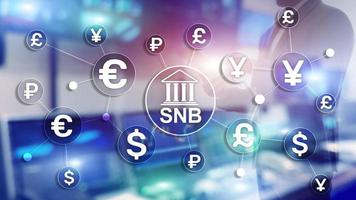 Different currencies on a virtual screen. SNB. Swiss National Bank. photo