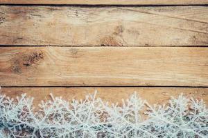 Wooden brown christmas background and snowflakes with space. photo