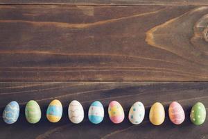 Top view of Easter eggs on rustic wood background with copy space photo