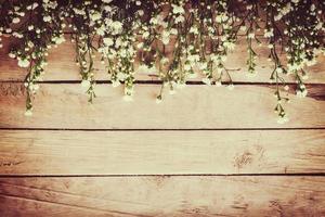 White flower on grunge wood board background with space. photo