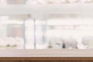 Empty wooden table top with blurred modern shopping mall background for product display and montage. photo