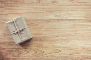 Brown gift box on wooden table background with copy space photo